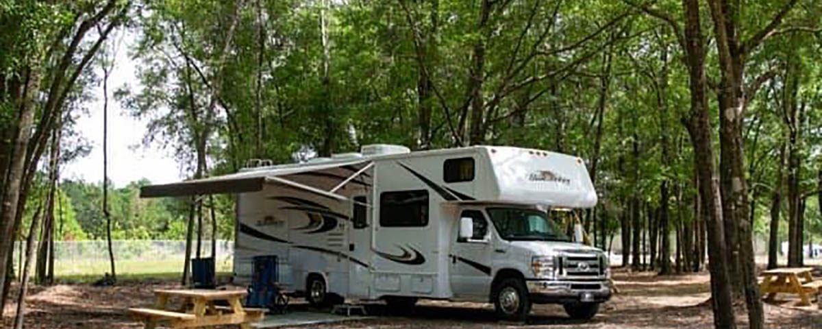 Shaded RV campsite at The Oaks RV Park in Andalusia, Alabama, perfect for overnight and extended stays