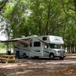 Shaded RV campsite at The Oaks RV Park in Andalusia, Alabama, perfect for overnight and extended stays