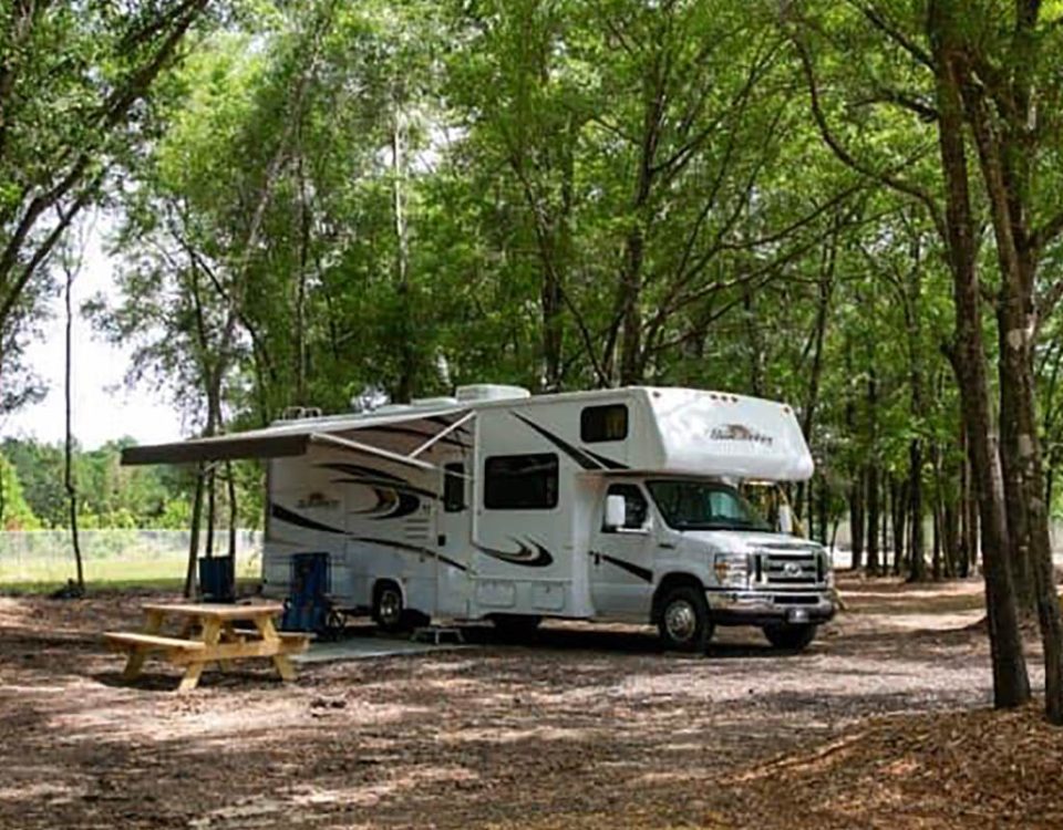 Shaded RV campsite at The Oaks RV Park in Andalusia, Alabama, perfect for overnight and extended stays