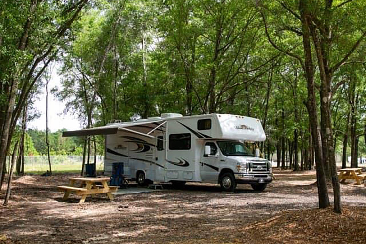 Shaded RV campsite at The Oaks RV Park in Andalusia, Alabama, perfect for overnight and extended stays